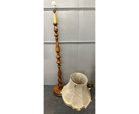 A turned wooden standard lamp.