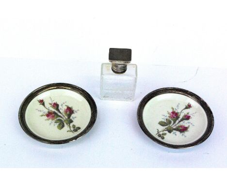 A pair of sterling silver mounted Rosenthal dishes Dia. 10.5cm, together with a white metal topped etched glass perfume bottl