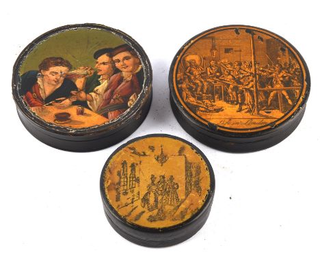An early 19th century papier mache snuff box, the circular lid hand painted with three scholars within an interior, 9cm diame