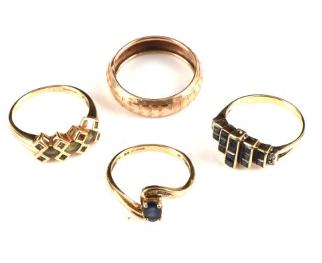 Four rings, including an Art Deco style table cut sapphire and diamond ring stamped 14 ct, size O, an oval cut sapphire and m