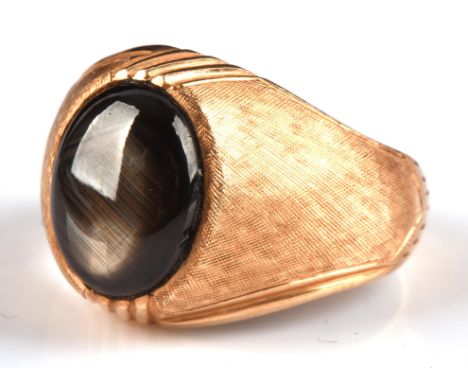 Star sapphire signet ring, cabochon 11mm x 9mm, set within textured matt shoulders, stamped 18 ct, ring size O 1/2Condition R