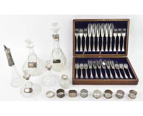 A group of seven silver napkin rings, various dates, together with a pair of small cut glass and silver mounted ships's decan