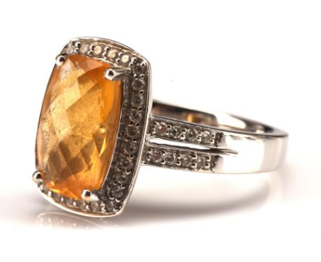 Citrine and diamond dress ring, rectangular chequerboard citrine weighing an estimated 3.40 carats, surrounded by diamonds wi