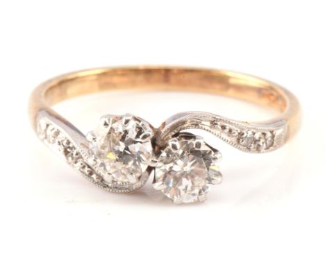 Diamond twist 'Toi et Moi' ring, estimated total diamond weight 0.70 carat, with diamond set shoulders, stamped 18 ct and pla