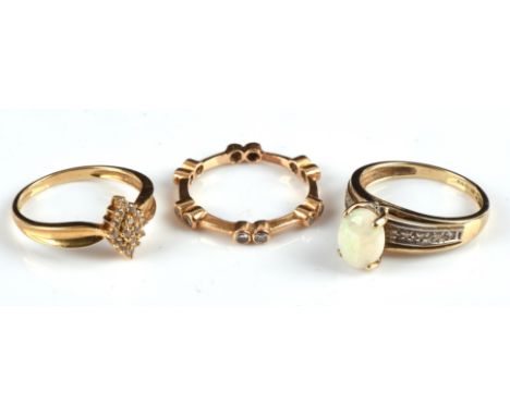 Three gems stone rings, including an opal cabochon ring set with split diamond shoulders size O1/2, a diamond cluster ring wi