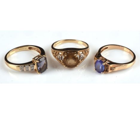 Three gem set rings, including an oval tanzanite ring with diamond shoulders, stamped 14 ct, ring size O, a round cut Citrine
