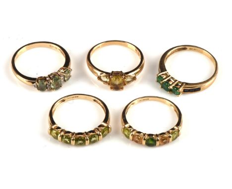 Five gem stone rings, including an oval cut fancy coloured green sapphire and moissanite ring, a round cut five stone Peridot