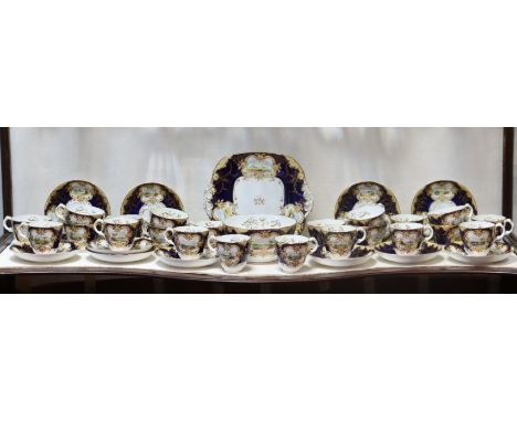 A 19th century English porcelain part tea &amp; coffee service, the blue &amp; gilt borders painted with landscape scenes, co