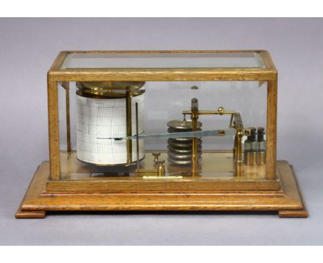 An early 20th century brass barograph, with applied label “Chadburns Ltd, Opticians, Liverpool”, in glazed oak case on bracke