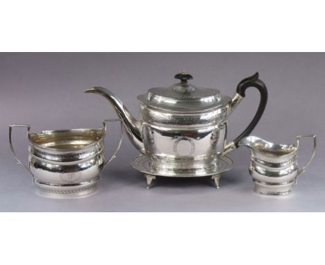 A George III silver matched four-piece tea service, each of oval shape with engraved foliate borders, comprising teapot &amp;