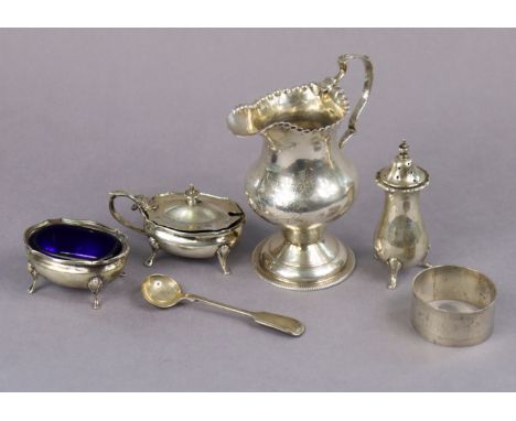 A George IV silver milk jug of inverted pear shape, with crimped rim, shaped loop handle, &amp; on round pedestal foot, 10.5c