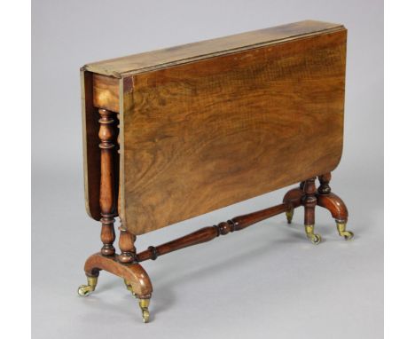 A mid-Victorian walnut Sutherland table on turned end supports, with brass toes &amp; ceramic castors, open; 98cm x 108cm x 7