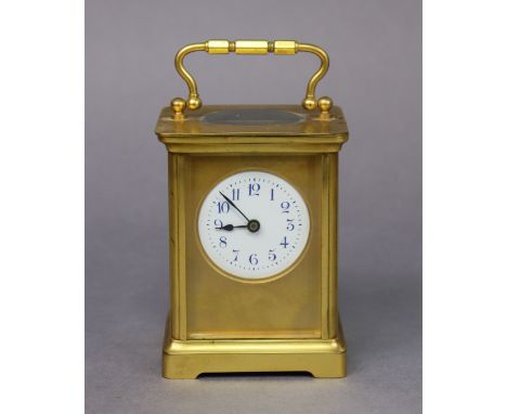 A gilt-brass carriage timepiece with blue Arabic numerals to the 4.5cm circular enamel dial, 10.5cm high.