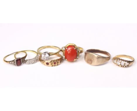 A yellow metal signet ring marked “9ct” (5.8gm);an 18ct. gold ring set three small diamonds; four various gold gem-set rings 