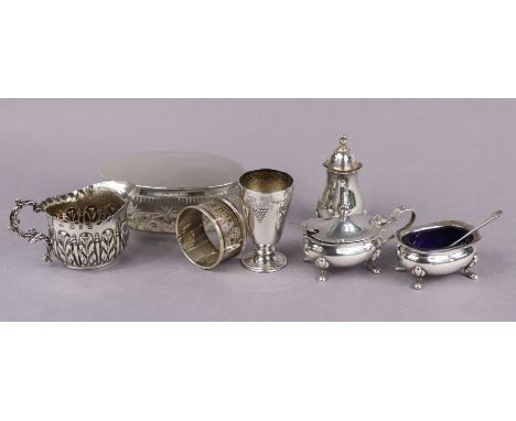 A silver three-piece condiment set with card-cut rims, London 1894; a late Victorian leaf-embossed cream jug, 5cm high; Birmi