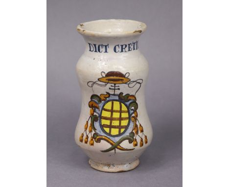 An 18th century Italian faience albarello inscribed “Dict Cretic”, of waisted form with painted polychrome decoration, 19cm h
