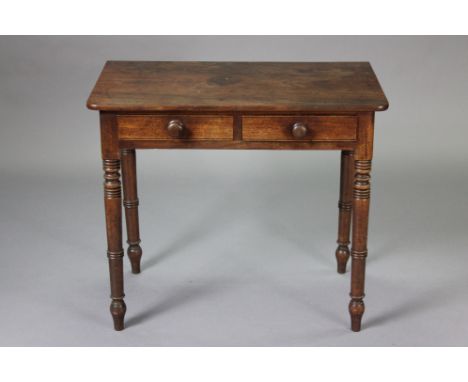 A Victorian mahogany side table with rounded corners to the rectangular top, fitted two frieze drawers with turned knob handl