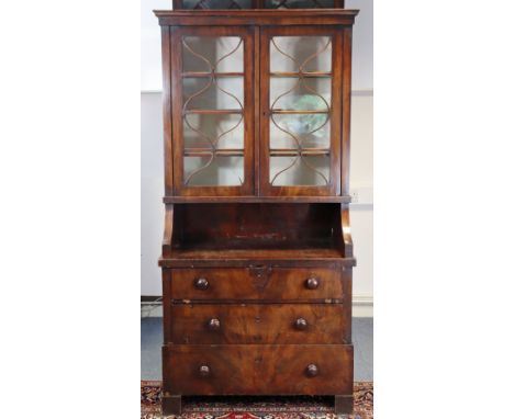 An early 19th century French fruitwood bookcase with three shelves to the upper part enclosed by pair of glazed doors, a deep