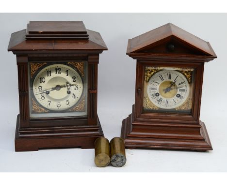 Three clocks, two being mahogany cased bracket clocks, striking on gong, with an ebonised wall clock, with porcelain dial and