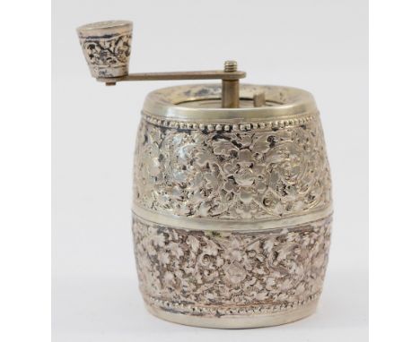 A floral embossed unmarked silver pepper grinder, made in France, 8cm.