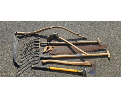 A collection of garden tools, to include a scythe and two axes