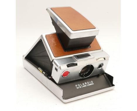 A Polaroid Land Canera, SX-70 Alpha 1, in tan, with leather carry case.