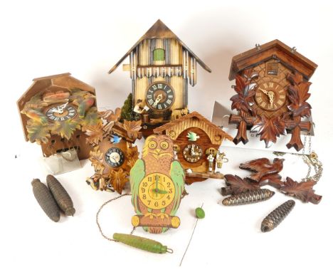 A collection of four mid-twentieth century Black Forest cuckoo clocks, having single and twin train manual wind movement, sui
