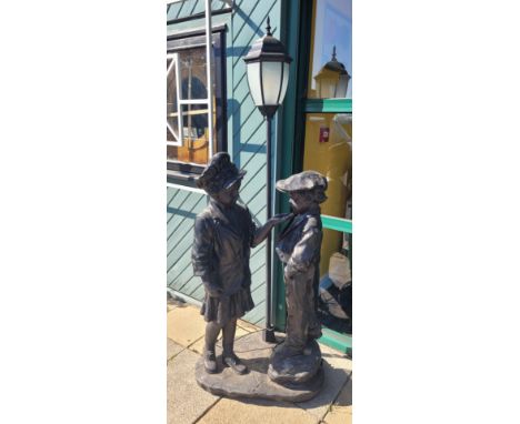 A contemporary lifesize figural floor lamp modelled as a boy and girl, height 172 cm.