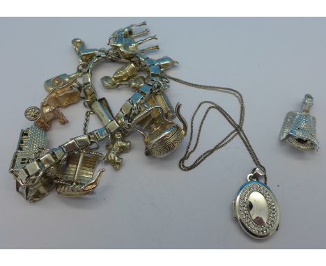 A silver charm bracelet and a locket with chain, total weight 68.7g