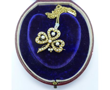 A yellow metal, pearl and diamond pendant on a 15ct gold chain, pendant loop added to original brooch, 9.8g