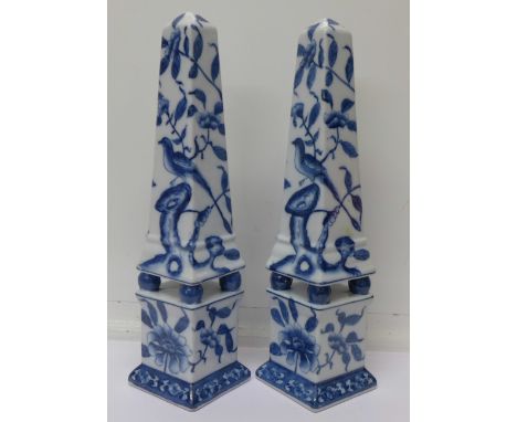 A pair of oriental blue and white ceramic obelisks, 33.5cm