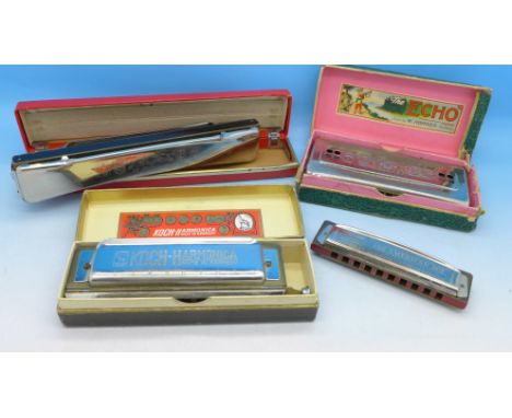 Three Hohner harmonicas including American Ace and Echo, and a Koch Chromatic harmonica, (4)