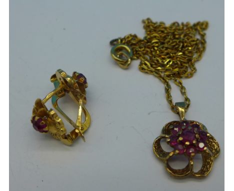 A 9ct gold and ruby pendant and chain and a pair of yellow metal and ruby earrings with continental control marks, 5.6g