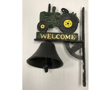 A painted cast metal sign inscribed "Welcome" and decorated with a tractor and bell 32 x 20 cm