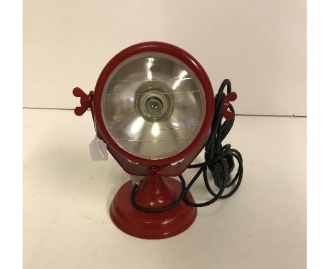 A red tractor headlight style table lamp, 27 cm high