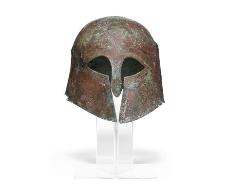  A Greek bronze Pseudo-Corinthian helmet  Magna Graecia, circa late 6th to early 5th Century B.C.with finely incised decorati