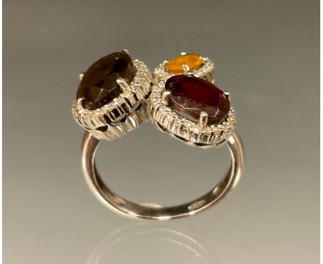 A 14ct gold dress ring set with oval citrine, garnet and smoky quartz stones, each surrounded by diamond accents, white gold 