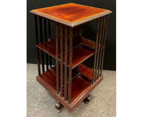 An Edwardian mahogany revolving bookcase, satinwood cross-banded top, two tiers of shelving, ceramic casters, 86cm high x 47c