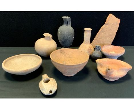 Antiquities - a Roman terracotta oil lamp of rough triform, 13cm wide, c.100-300AD; a Roman Palestinian oil lamp of typical f