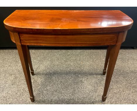 A Sheraton revival mahogany D-shaped card table, tapered square legs, spade feet, 73cm high x 90cm wide x 44cm deep. 