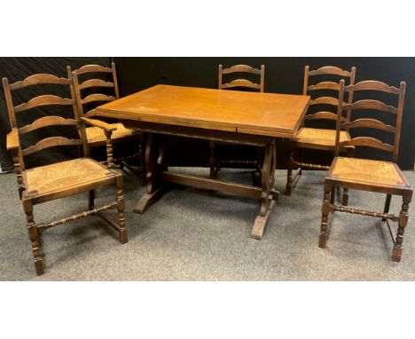 A Jaycee type oak draw-leak trestle dining table, carved frieze, 77.5cm high x 81cm x 122cm (opening to 182.5cm);  a set of f