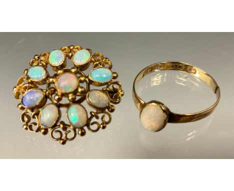 An opal shield brooch, open setting set with nine opal cabochons, scrolled and ball details, stamped 9ct, 2.2cm diameter, 3.1