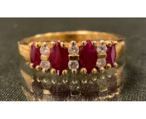 A diamond and ruby ring, liners set with four oval graduated deep red rubies, each divided by pairs of round brilliant cut di