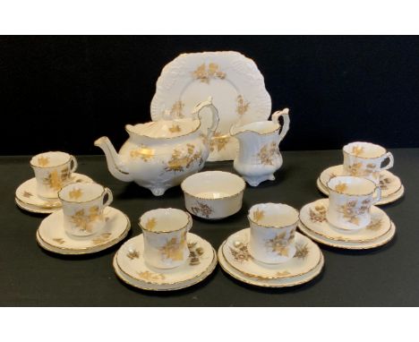 A Hammersley and Co tea service, decorated with gilded flowers tea service for six comprised of; a tea pot, sugar bowl, milk 