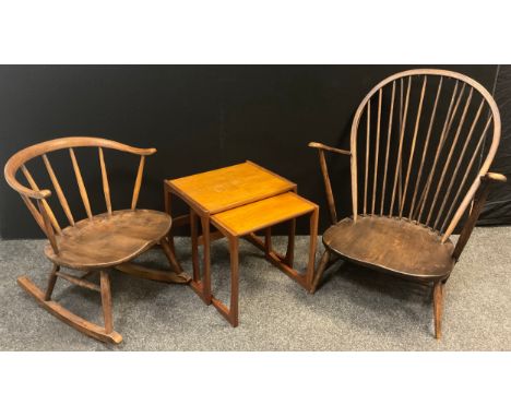 An Ercol ‘Cow-horn’ elm and beech-wood rocking chair, 66cm high x 56.5cm wide;  an Ercol low arm-chair;  a nested pair of G-p