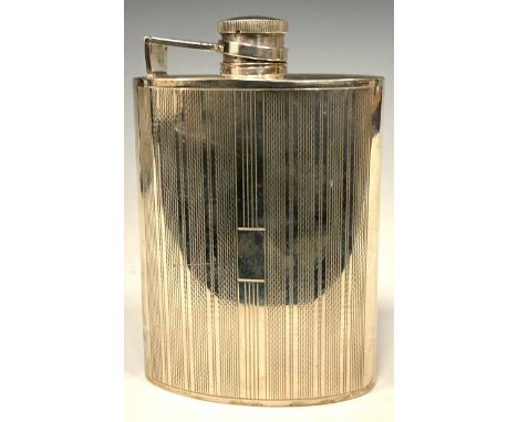 An Art Deco style silver curved rounded rectangular hip flask, engine turned in bands, hinged bayonet cap, 12cm long, marked 