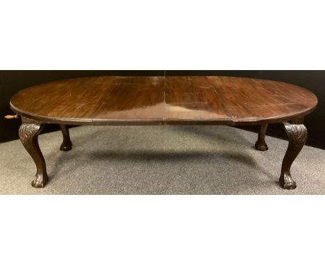 A Victorian mahogany oval extending dining table, large carved cabriole legs, ball and claw feet, ceramic casters, two extra 