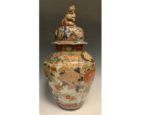 A large Japanese Imari octagonal jar and cover, Shishi finial, decorated blossoms, shishi and garden panels, 49cm high. 