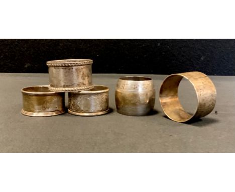 A Victorian silver napkin ring,  London 1882, others later, 5.06ozt (5) 