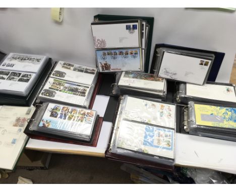 A large collection of assorted first day covers including Wallace and gromit Alice in Wonderland etc.